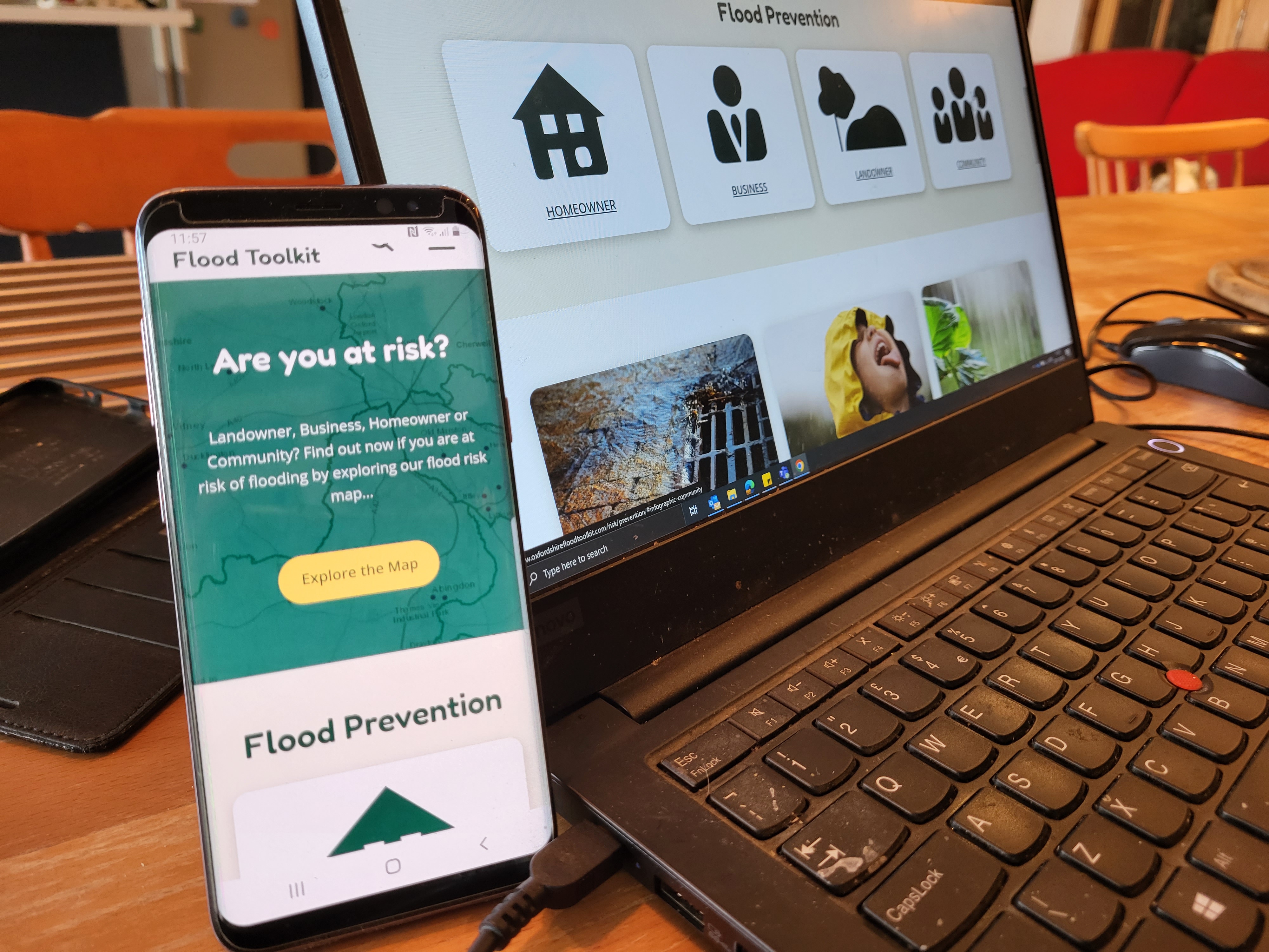 A phone and a laptop with the Oxfordshire Flood Toolkit site