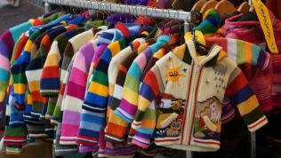 Colourful children's jackets on a clothing rack