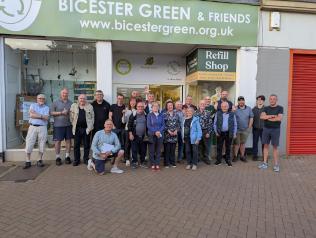A large group of volunteers smiling out the front of Bicester Green