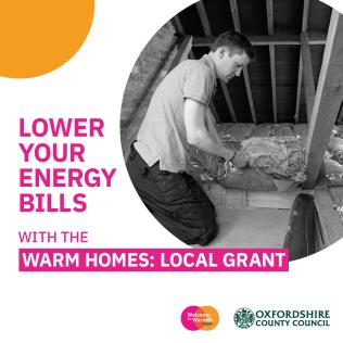 A man installing insulation in the flooring of an attic.