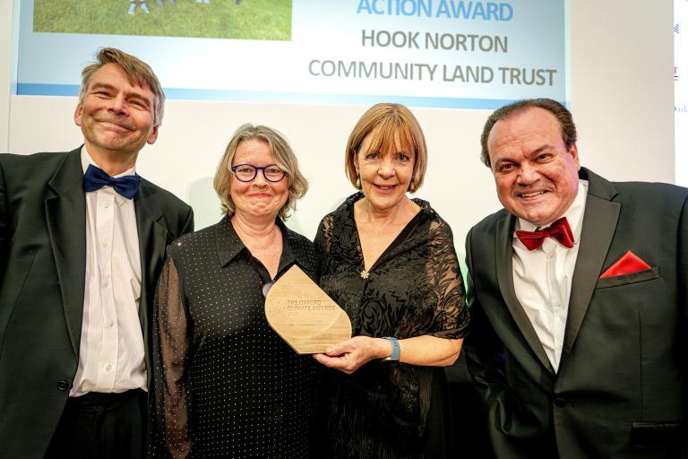 Councillor Andrew Gant and host Shaun Williamson presenting the Innovation in Climate Action Award to Hook Norton Community Land Trust