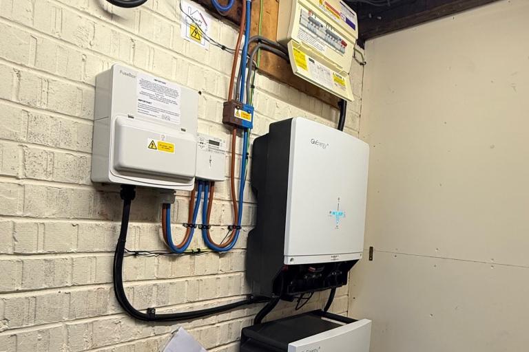 A battery storage and hybrid invertor for a Solar PV installation, attached to a wall inside a house.