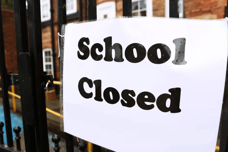 A 'school closed' sign on school gates.