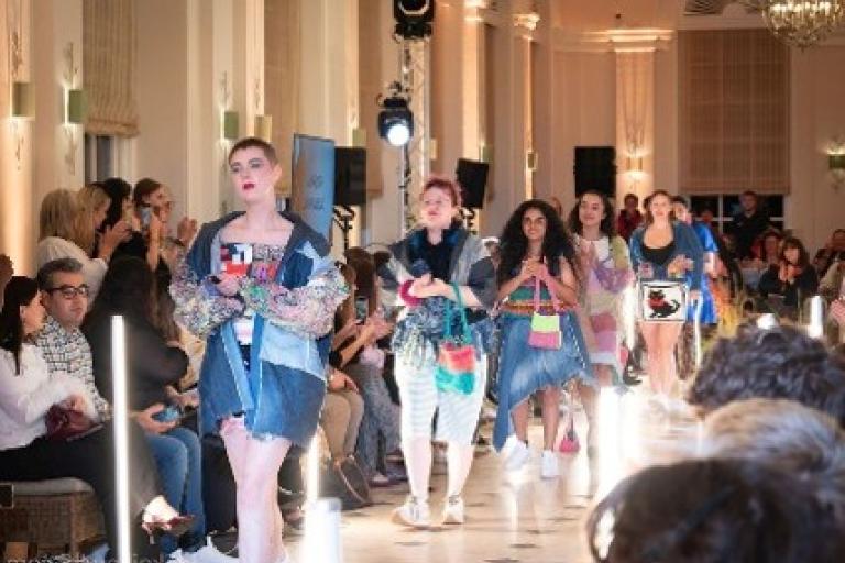 Models walk down a runway.