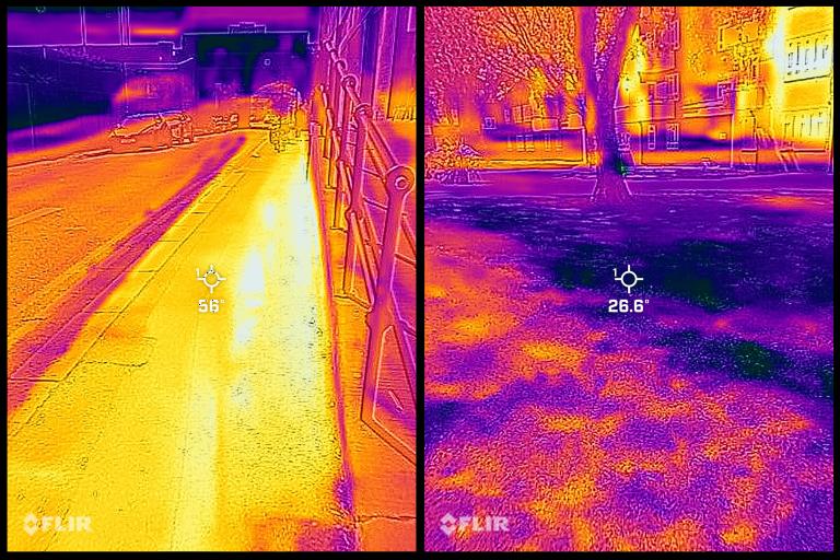 A thermal imaging camera shows cooler surfaces under trees.