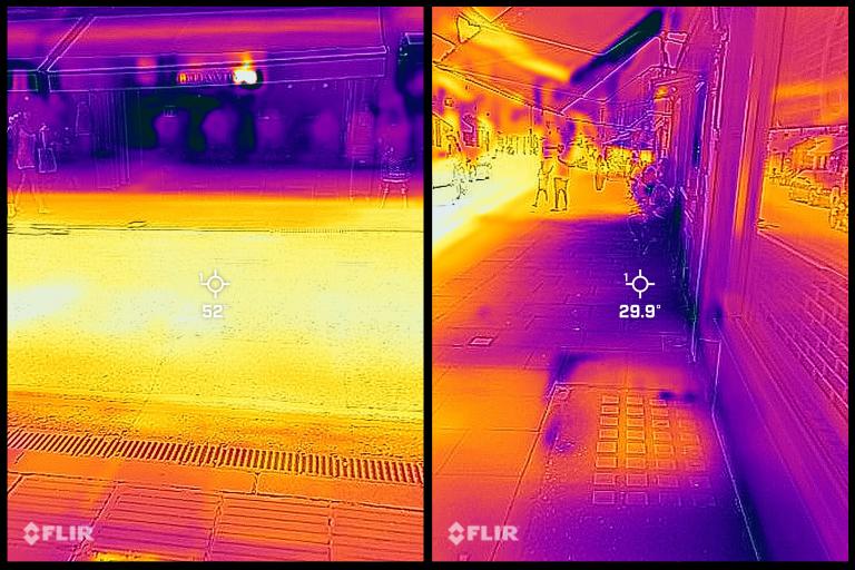 A thermal imaging camera shows cooler temperatures under shop awnings.